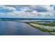 Expansive aerial view of a coastal community featuring modern condos, a bridge, and scenic water views at 910 Tidewater Shores Loop # 103, Bradenton, FL 34208