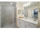 Modern bathroom features a glass-enclosed shower, and bright white vanity with quartz countertop at 910 Tidewater Shores Loop # 103, Bradenton, FL 34208