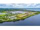 Expansive aerial view showcasing the community's waterfront homes, pool, tennis courts and marina at 910 Tidewater Shores Loop # 103, Bradenton, FL 34208