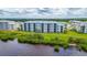 Modern condominium exterior showcasing waterfront views, lush landscaping and serene community at 910 Tidewater Shores Loop # 103, Bradenton, FL 34208