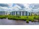 Beautiful condominium exterior boasting waterfront views and verdant landscaping at 910 Tidewater Shores Loop # 103, Bradenton, FL 34208