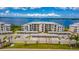 Apartment building exterior with waterfront view and parking, enhanced by a vibrant blue sky with picturesque clouds at 910 Tidewater Shores Loop # 103, Bradenton, FL 34208