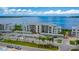 Stunning condominium exterior featuring covered parking, lush landscaping, and serene water views at 910 Tidewater Shores Loop # 103, Bradenton, FL 34208