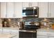 Stainless appliances, modern backsplash, and countertops in the kitchen at 910 Tidewater Shores Loop # 103, Bradenton, FL 34208