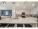 Large island has seating, stylish pendant lights, stainless appliances, and custom backsplash at 910 Tidewater Shores Loop # 103, Bradenton, FL 34208