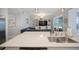 Spacious kitchen island with stainless steel sink and appliances, overlooks living space at 910 Tidewater Shores Loop # 103, Bradenton, FL 34208