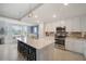Bright kitchen features modern white cabinets, stainless steel appliances, and a center island with bar seating at 910 Tidewater Shores Loop # 103, Bradenton, FL 34208