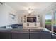 Bright living room features large sectional couch, entertainment center, and access to an outdoor patio at 910 Tidewater Shores Loop # 103, Bradenton, FL 34208