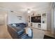 Comfortable living room with large sectional couch, entertainment center, and bright lighting at 910 Tidewater Shores Loop # 103, Bradenton, FL 34208