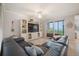 Comfortable living room with large sectional couch, entertainment center, and access to an outdoor patio at 910 Tidewater Shores Loop # 103, Bradenton, FL 34208