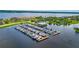 Aerial view of a well-maintained marina with numerous boats docked on the water at 910 Tidewater Shores Loop # 103, Bradenton, FL 34208