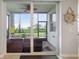 Cozy screened patio with comfortable seating, fan, and beautiful outdoor views at 910 Tidewater Shores Loop # 103, Bradenton, FL 34208