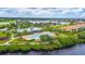 Community pool with water views surrounded by tropical vegetation and beautiful landscaping at 910 Tidewater Shores Loop # 103, Bradenton, FL 34208