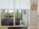 Patio view through sliding glass doors onto an outdoor seating area with serene views of green space at 910 Tidewater Shores Loop # 103, Bradenton, FL 34208