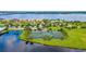 Scenic aerial view of well-kept tennis courts near the water and beautiful homes at 910 Tidewater Shores Loop # 103, Bradenton, FL 34208
