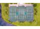 Overhead shot of meticulously maintained tennis courts surrounded by lush greenery at 910 Tidewater Shores Loop # 103, Bradenton, FL 34208