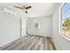 Cozy bedroom with a mini-split AC unit, fresh paint, and sleek wood-style floors at 920 Myrtle Ave, Venice, FL 34285