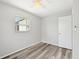 Cozy bedroom with wood look floors, a window, and a closet at 920 Myrtle Ave, Venice, FL 34285