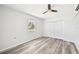 Airy bedroom featuring a ceiling fan, window, closet, and modern gray-toned floors at 920 Myrtle Ave, Venice, FL 34285
