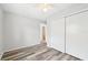 Clean bedroom with light gray walls, wood-look floors, and a large closet, offering ample storage space at 920 Myrtle Ave, Venice, FL 34285