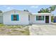 Charming home with a white exterior, complemented by vibrant turquoise shutters and a well-maintained yard at 920 Myrtle Ave, Venice, FL 34285