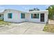 Attractive home with eye-catching turquoise shutters and a well-kept lawn at 920 Myrtle Ave, Venice, FL 34285