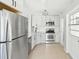 Bright kitchen featuring stainless steel appliances, white cabinetry, and an elegant light fixture at 920 Myrtle Ave, Venice, FL 34285