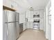 Modern kitchen with stainless steel appliances, white cabinets, subway tile backsplash, and a new dishwasher at 920 Myrtle Ave, Venice, FL 34285