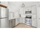 Modern kitchen with stainless steel appliances, white cabinets, and a subway tile backsplash at 920 Myrtle Ave, Venice, FL 34285