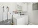 Functional laundry room with washer, dryer, and storage cabinets above at 920 Myrtle Ave, Venice, FL 34285