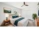 Serene main bedroom features a comfortable bed, coordinated decor, a ceiling fan, and ample natural light at 920 Myrtle Ave, Venice, FL 34285