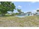 View of the yard of a home with a pool in the background at 920 Myrtle Ave, Venice, FL 34285