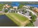 Aerial view of the community clubhouse, golf course, parking, lakes, and surrounding homes at 935 River Basin Ct # 102B, Bradenton, FL 34212