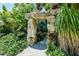 Unique backyard showcases a rock archway and lush tropical landscaping at 102 & 104 48Th St, Holmes Beach, FL 34217
