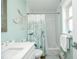 Bathroom features a shower-tub combo, nautical decor, and a classic white vanity sink at 102 & 104 48Th St, Holmes Beach, FL 34217