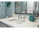 Close-up of a bathroom sink featuring coral decor and a classic white vanity sink at 102 & 104 48Th St, Holmes Beach, FL 34217