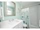 Bright bathroom features a shower-tub combo, mermaid decor, and a classic white vanity sink at 102 & 104 48Th St, Holmes Beach, FL 34217