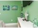 Bright bedroom featuring green walls, decorative accents, and a TV, creating a cozy and inviting space at 102 & 104 48Th St, Holmes Beach, FL 34217