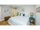 Bright bedroom features coastal decor, a queen-sized bed, and a decorative chest at 102 & 104 48Th St, Holmes Beach, FL 34217