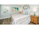 A bedroom features a queen-sized bed, coastal décor, and light-colored walls at 102 & 104 48Th St, Holmes Beach, FL 34217