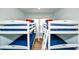 Spacious bedroom showcases four bunk beds with matching blue bedding and red pillows at 102 & 104 48Th St, Holmes Beach, FL 34217