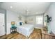 Cozy bedroom features wood-look tile flooring and coastal-themed décor with a queen-sized bed at 102 & 104 48Th St, Holmes Beach, FL 34217