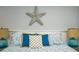 A decorative starfish hangs above the headboard of the queen-sized bed with coastal decorations at 102 & 104 48Th St, Holmes Beach, FL 34217