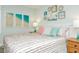 A bedroom is decorated with framed pictures, beachy decor, and a queen-sized bed at 102 & 104 48Th St, Holmes Beach, FL 34217