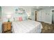 Bright bedroom features coastal-themed decor, a queen-sized bed, and access to an ensuite bathroom at 102 & 104 48Th St, Holmes Beach, FL 34217