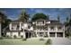 A luxurious three-story home featuring dual two-car garages and black trim at 102 & 104 48Th St, Holmes Beach, FL 34217