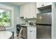 A compact, efficient kitchen with stainless steel appliances and white cabinets at 102 & 104 48Th St, Holmes Beach, FL 34217