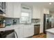 Modern kitchen with stylish backsplash, stainless appliances, and bright, clean countertops at 102 & 104 48Th St, Holmes Beach, FL 34217