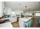 This contemporary kitchen boasts an island with seating and an open floor plan leading to the dining room at 102 & 104 48Th St, Holmes Beach, FL 34217