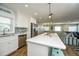 Bright and open kitchen with stainless appliances, breakfast bar, and seamless flow to dining and living areas at 102 & 104 48Th St, Holmes Beach, FL 34217